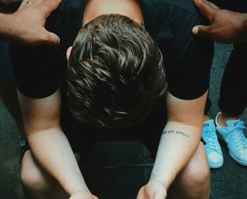 Man getting prayed for.
